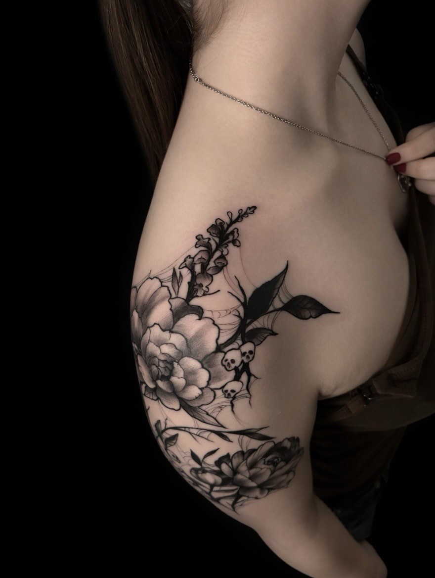 Alternate angle of a blackwork flower shoulder tattoo by Lucas Macauley
